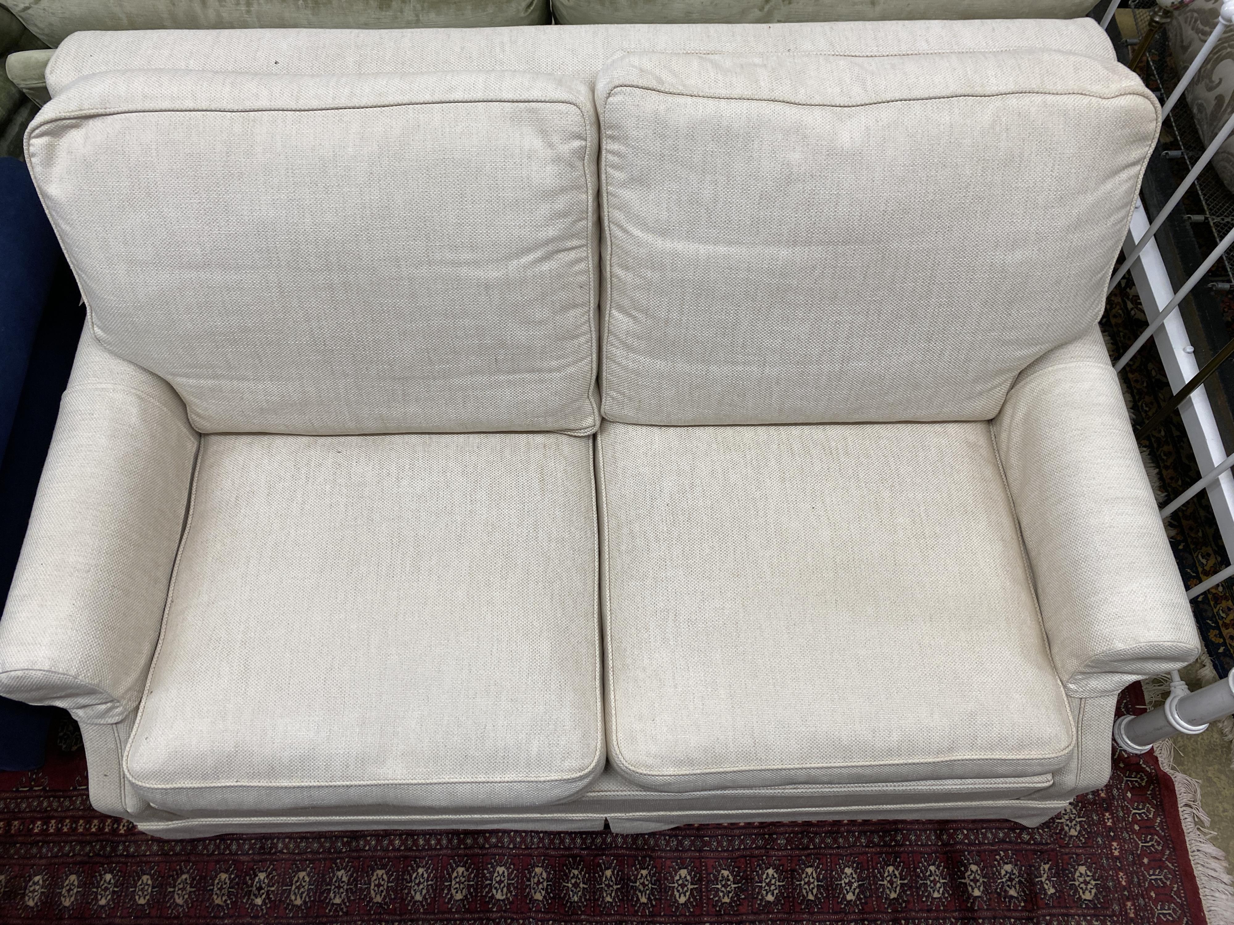 A Wesley Barrell cream fabric metal action two seater sofa bed, width 160cm, depth 96cm, height 82cm